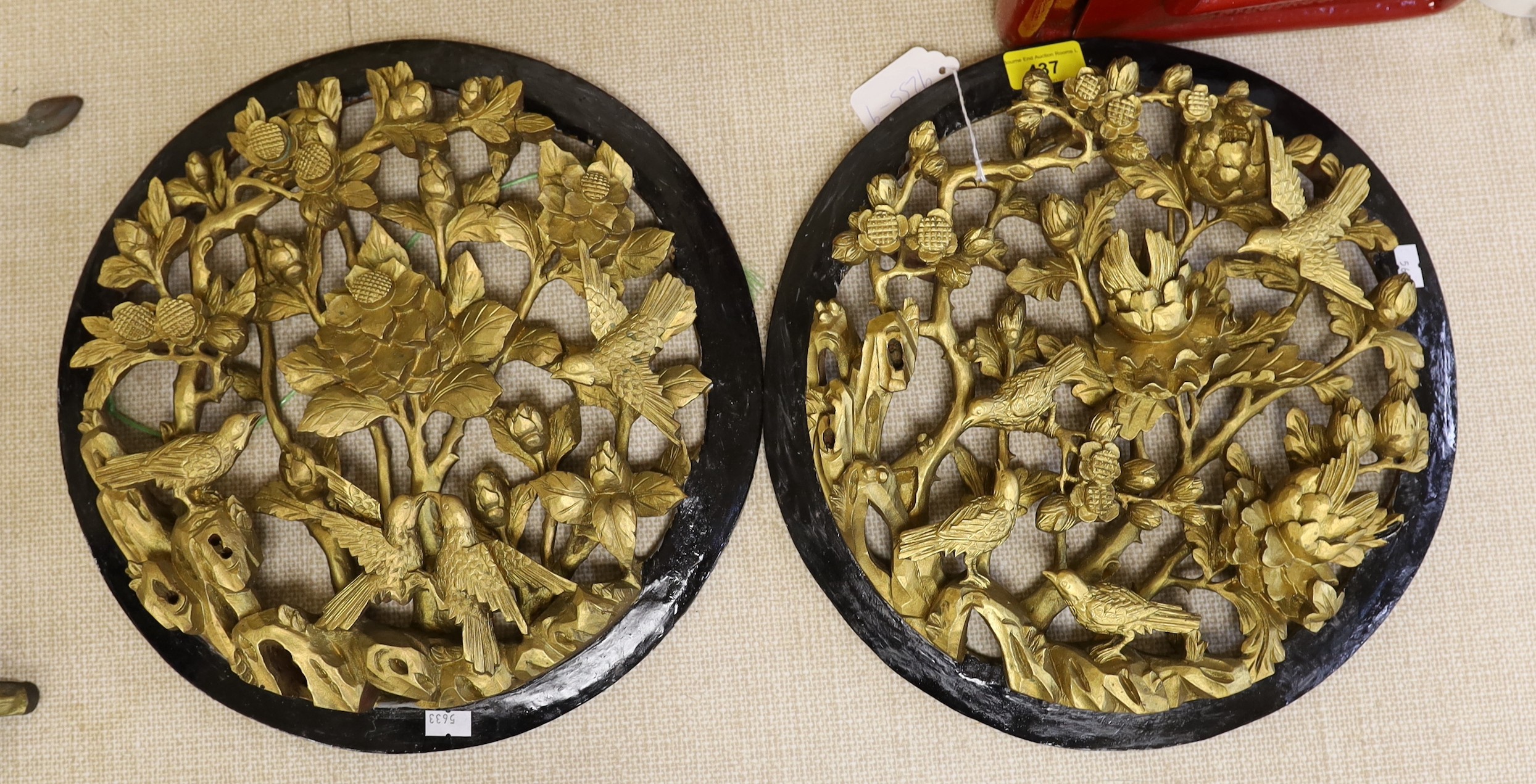 A pair of Chinese carved and gilded wood ‘birds and flowers’ roundels, 33.5cm